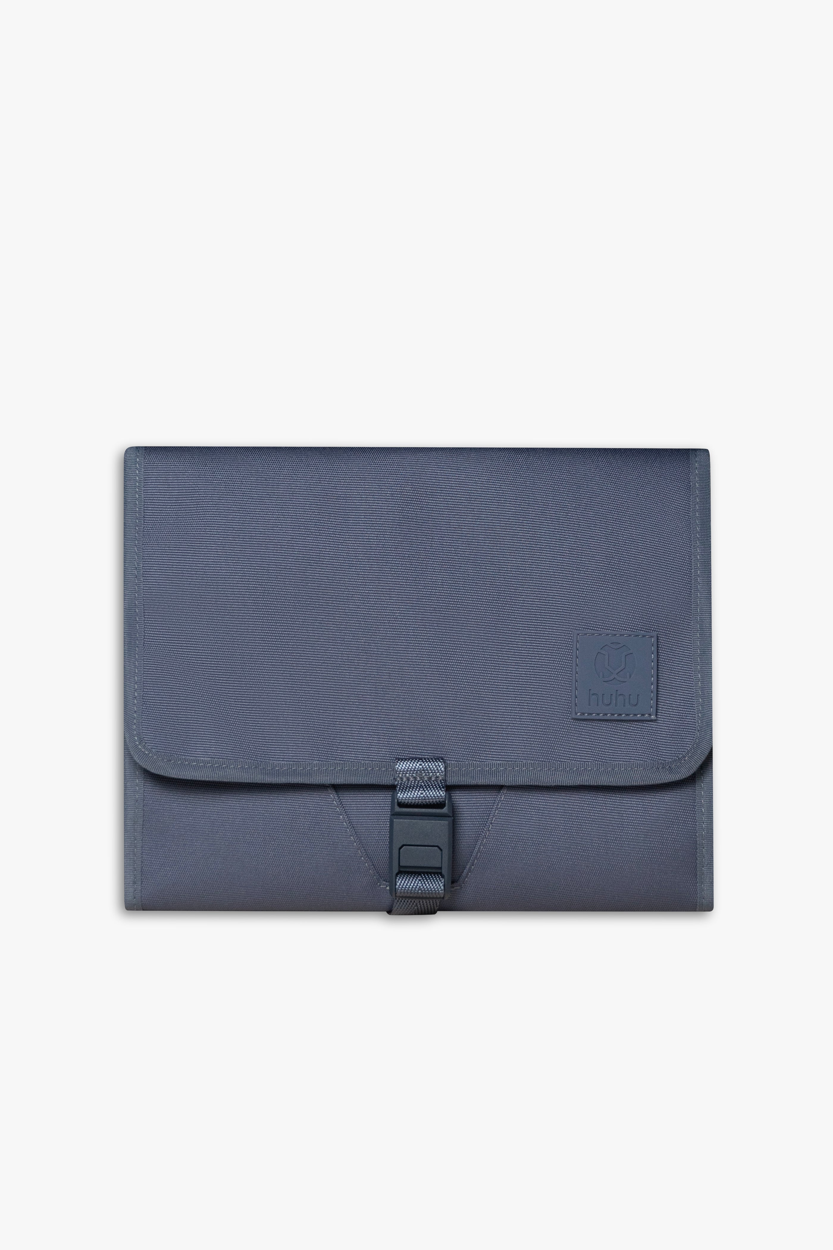 Front view of closed blue changing wallet against white background.