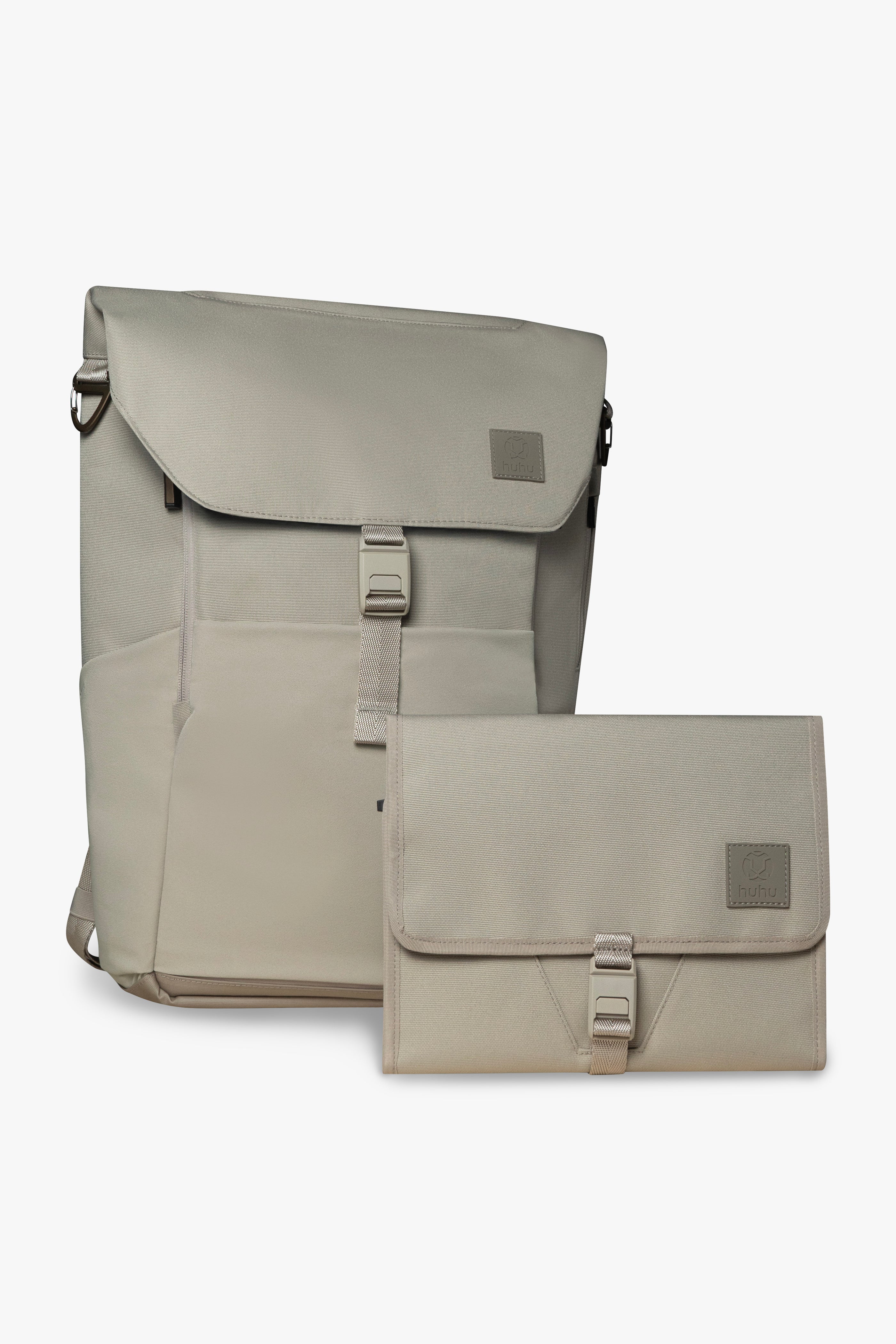 Front view of taupe backpack and changing wallet. Both are closed, and show magnetic clasp and exterior of products against white background.